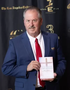 Ray Scott holds his book